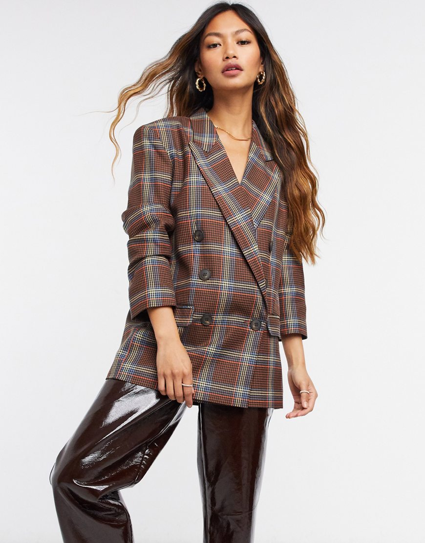 Model wearing ASOS DESIGN double breasted suit blazer in bold plaid