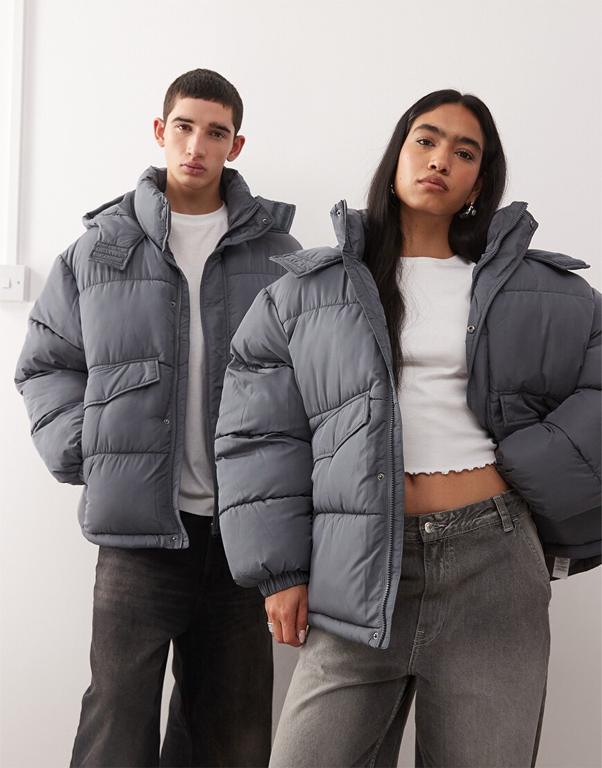 Man and woman wearing a grey puffer jacket