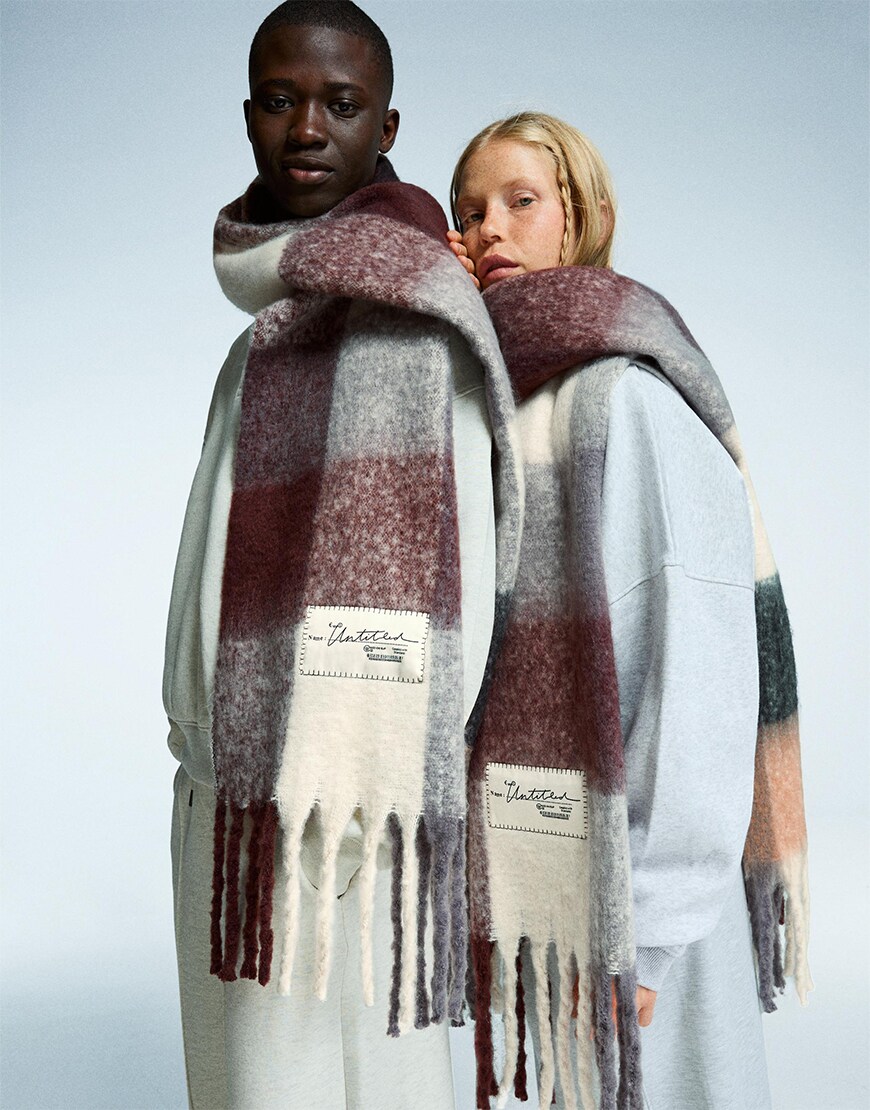 Man and woman wearing check scarves