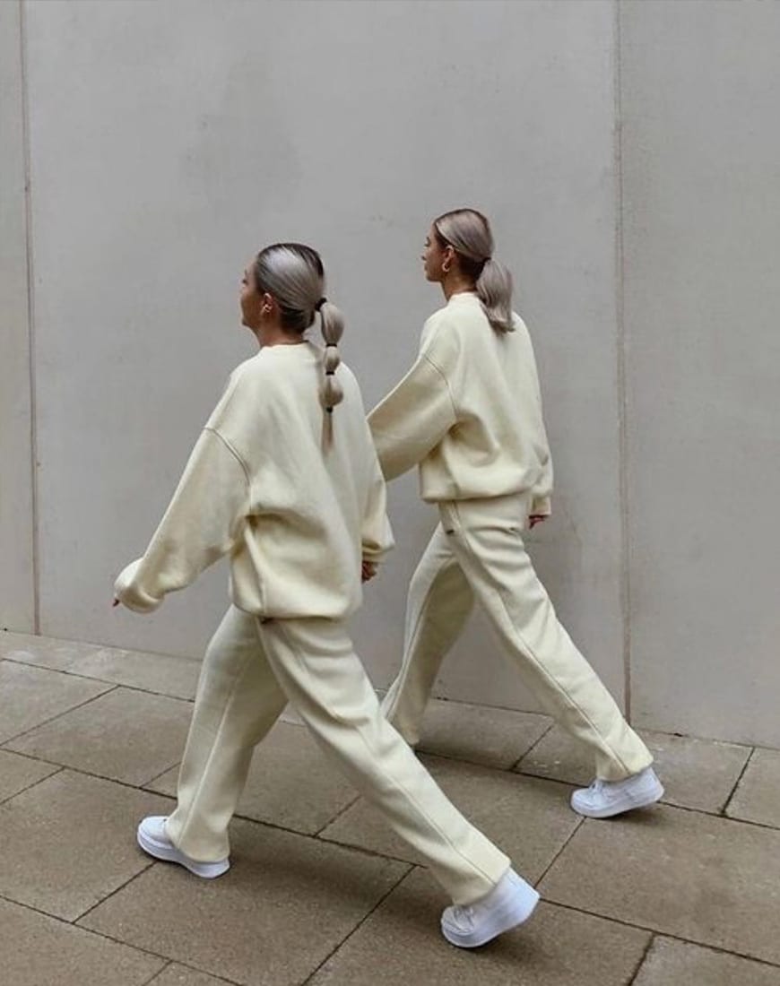 Two models wearing matching beige loungewear sets