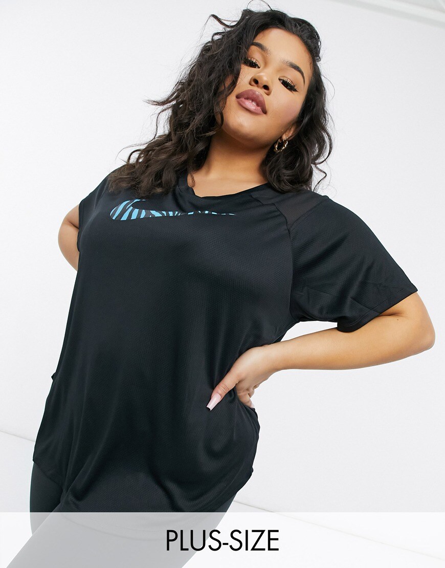 A picture of a model wearing a black Nike Running T-shirt featuring an animal print Swoosh. Available at ASOS | ASOS Style Feed