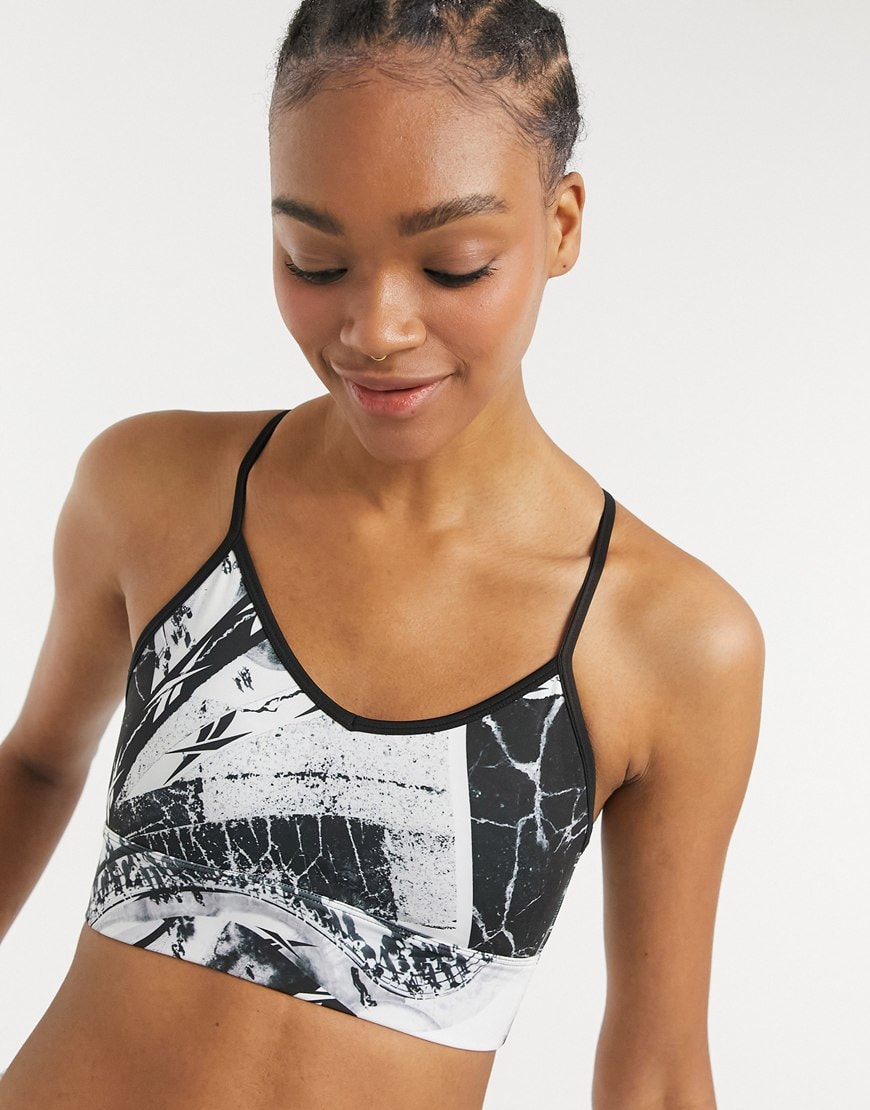 A picture of a model wearing a white and black Reebok gym bra. Available at ASOS | ASOS Style Feed