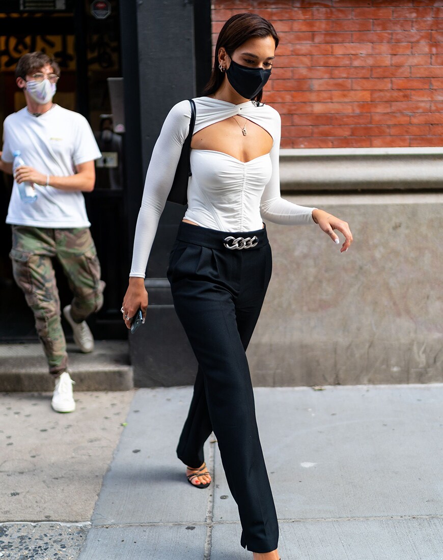 Dua Lipa in a white top and black trousers | ASOS Style Feed