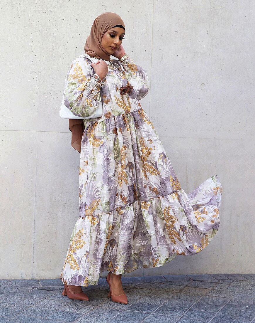 A woman wearing an oversized floral maxi dress, brown heels and a matching hijab | ASOS Style Feed