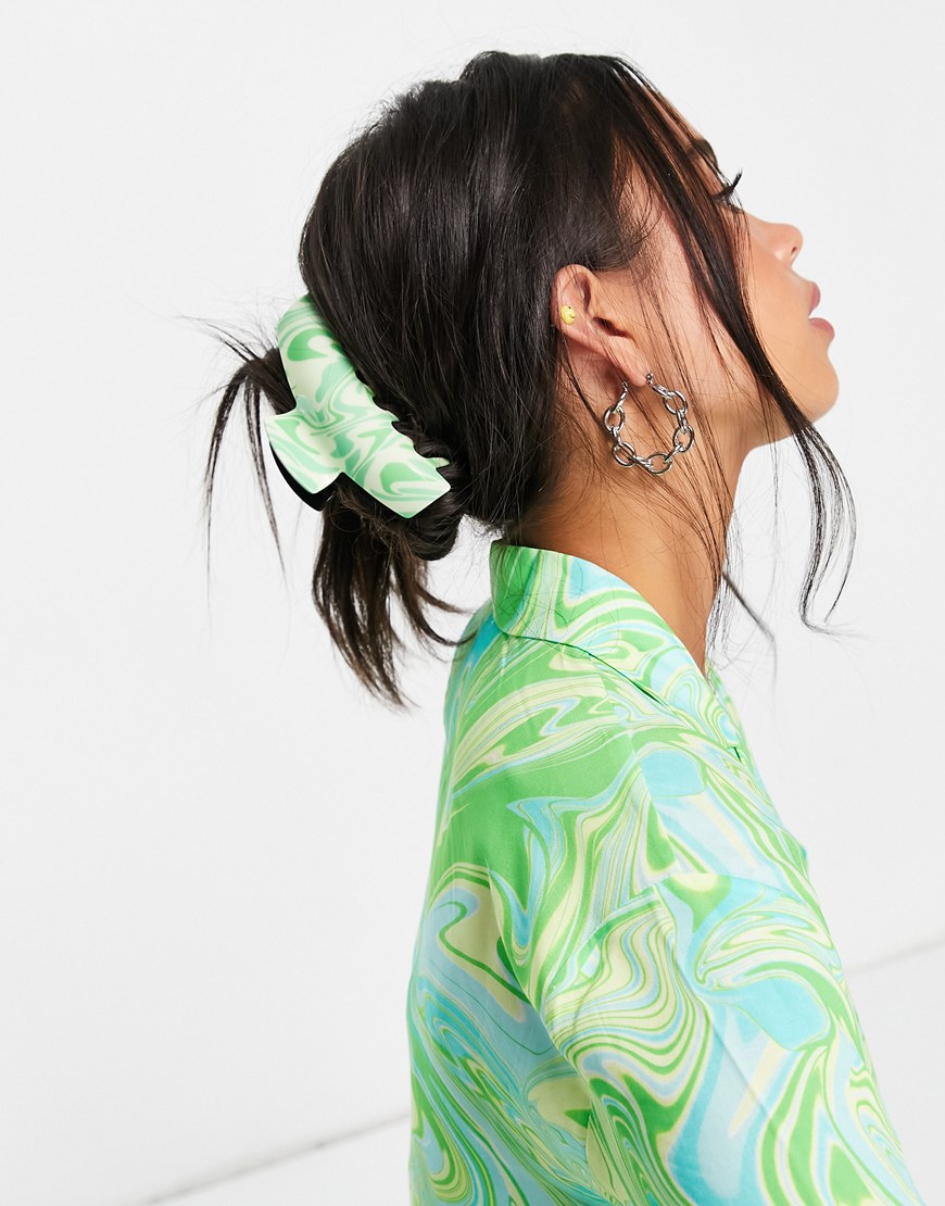 Woman wearing her hair up. It's being held in place by a green claw clip. | ASOS Style Feed