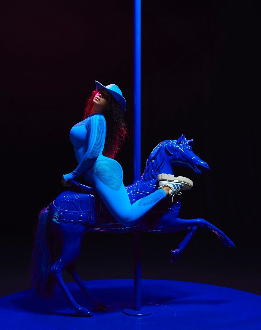 Beyonce on a carousel horse in an blue Ivy Park catsuit and a blue cowboy hat | ASOS Style Feed