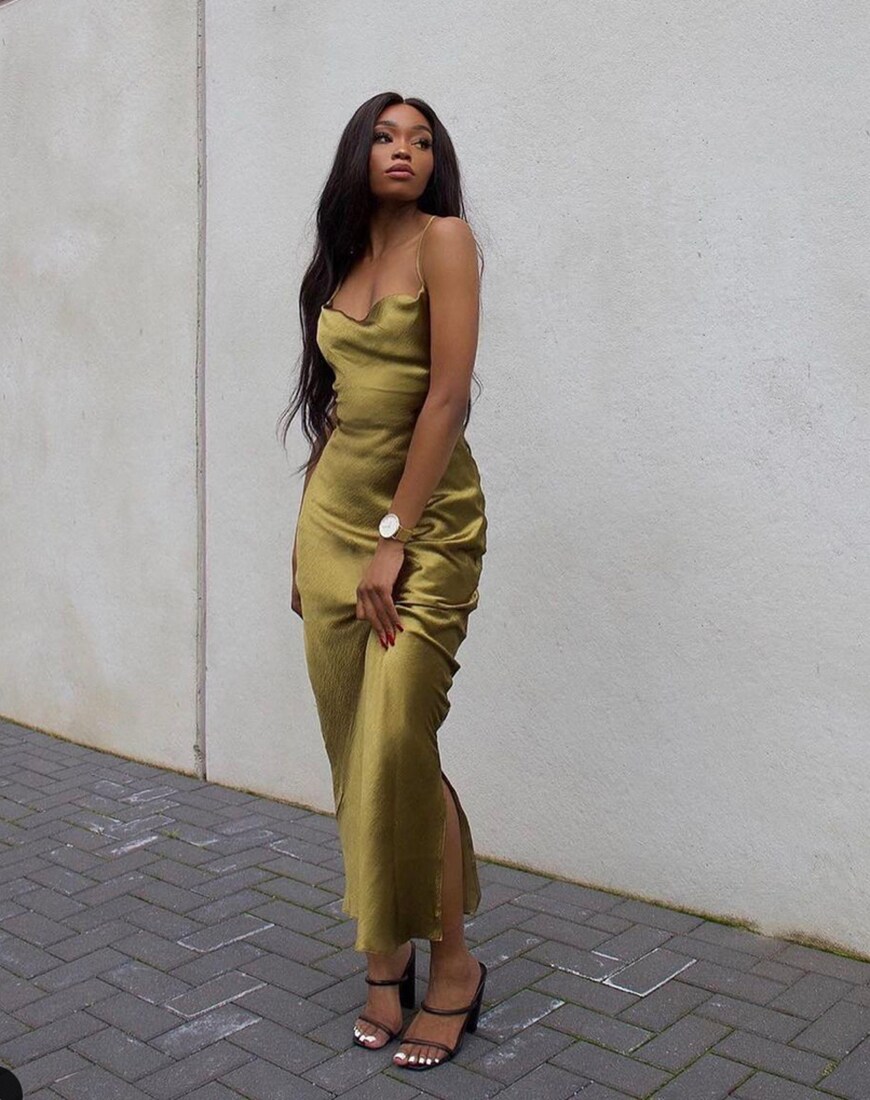 A woman wearing a slinky, gold-coloured maxi dress and heels | ASOS Style Feed