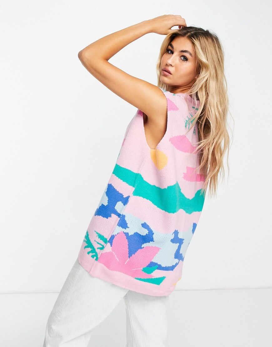 Model wears a knitted sleeveless cardie with a beach scene on it in pinks, greens, yellows and blues. | ASOS Style Feed