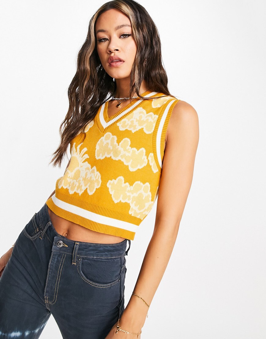 Model wears a yellow sweater vest with white and pale yellow clouds. | ASOS Style Feed