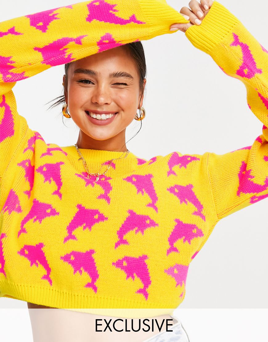 Model wears a bright yellow knit jumper with bright pink dolphins on it. | ASOS Style Feed