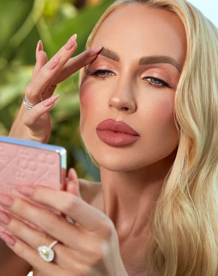 Christine Quinn is holding the Boss B*tch eyeshadow palette from her collection with Ciate London. | ASOS Style Feed