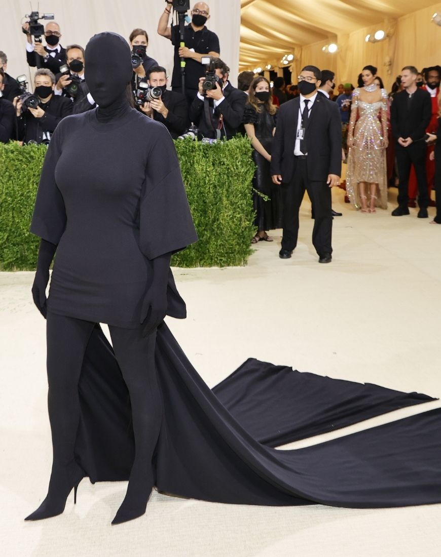 Kim Kardashian poses at the MET Gala wearing an all black ensemble covering everything, including her face. | ASOS Style Feed