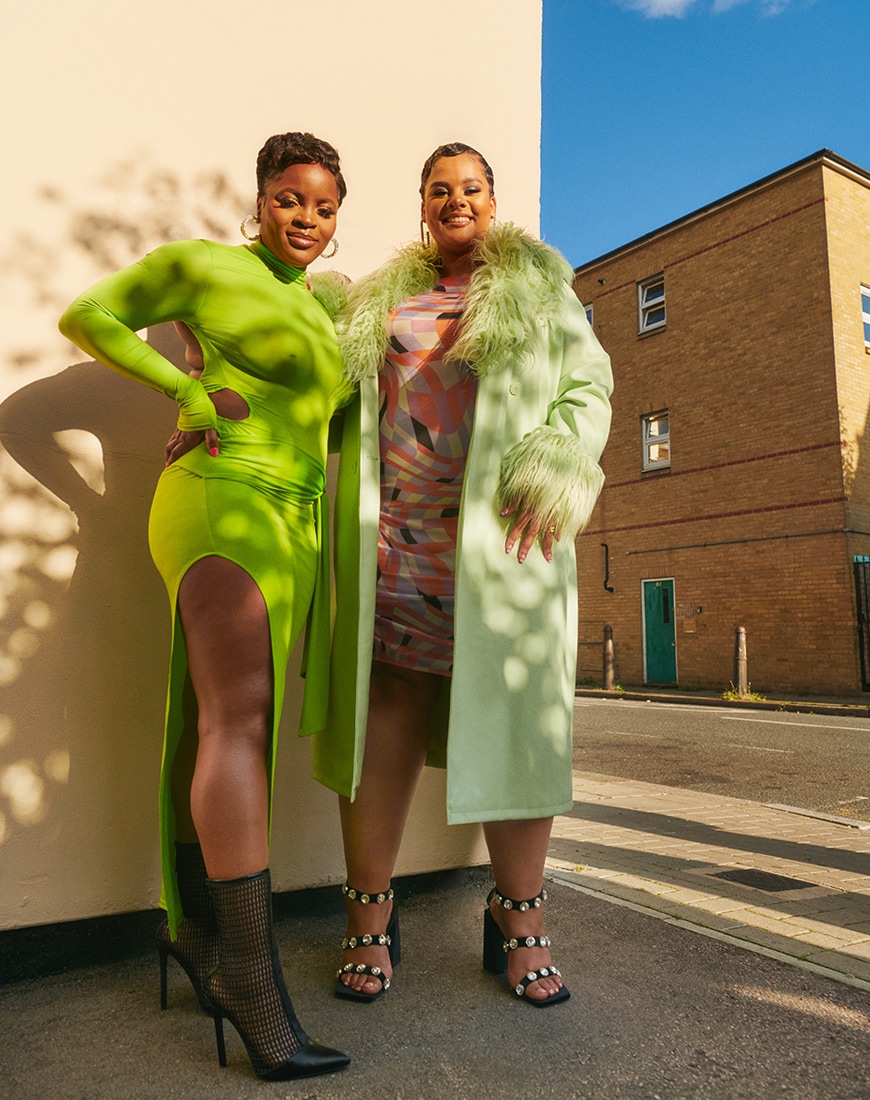 Tolly and Sophia stand together against a wall, smiling | ASOS Style Feed