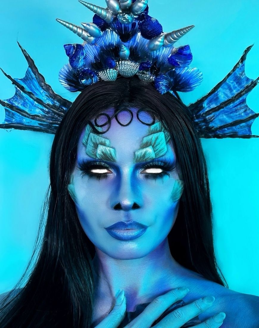 Amber has created a blue Siren-esque makeup look complete with fake scales and white contacts. | ASOS Style Feed