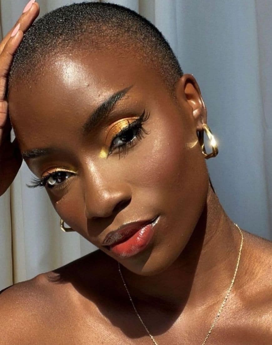 @whitneymadueke wears shiny, gold eyeshadow and gold-tinted body glitter. | ASOS Style Feed