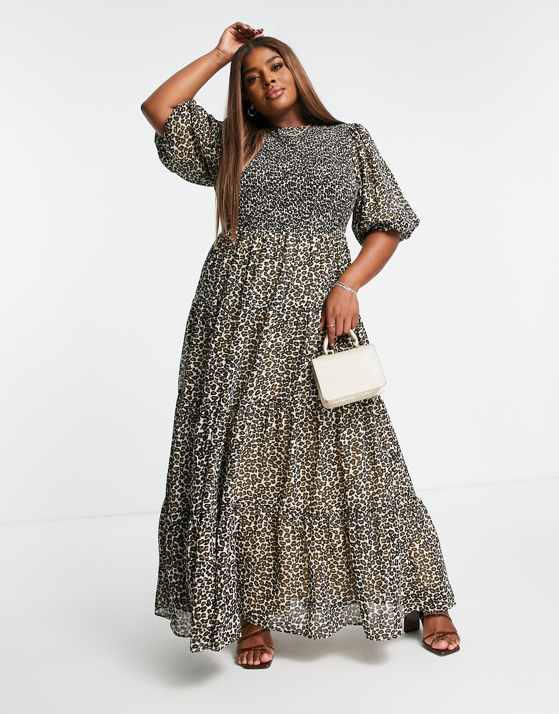 A picture of a model wearing a long ASOS DESIGN Curve leopard-print smock dress with a white purse. | ASOS Style Feed
