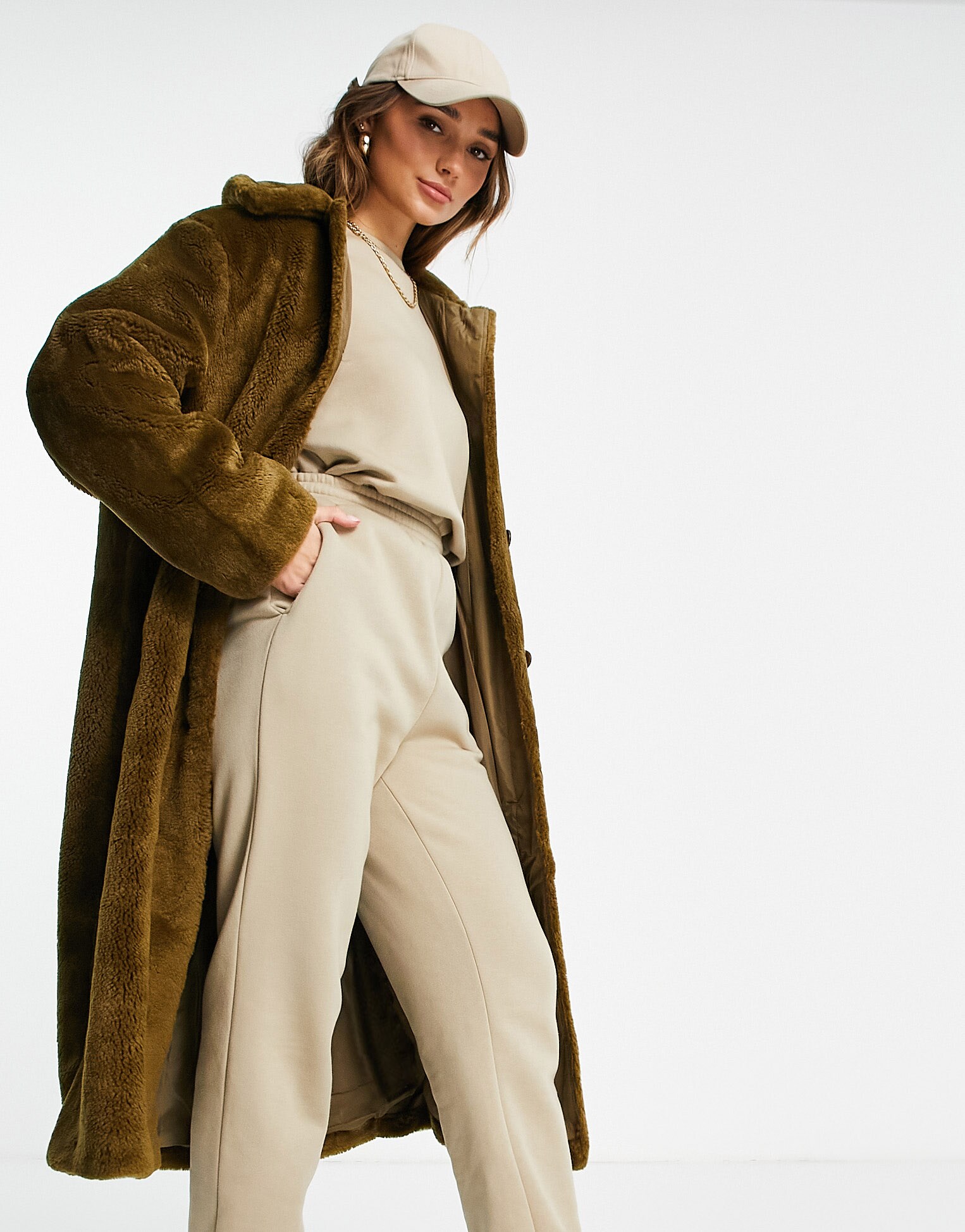 Model wears a stone colored sweatsuit with an ASOS DESIGN teddy button through coat in olive on top. | ASOS Style Feed