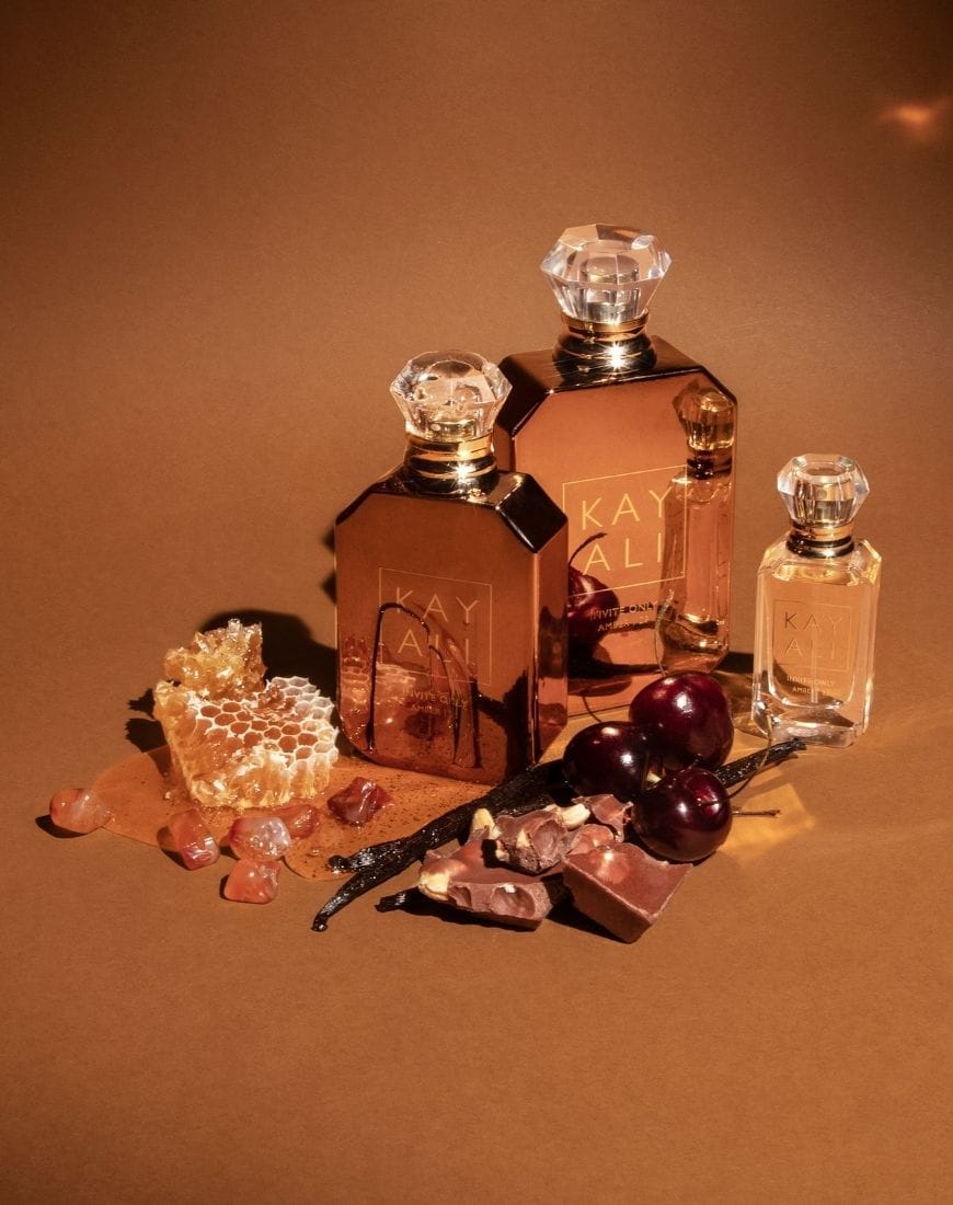 A picture of the Kayali Only Amber perfume against a dark brown backdrop. | ASOS Style Feed