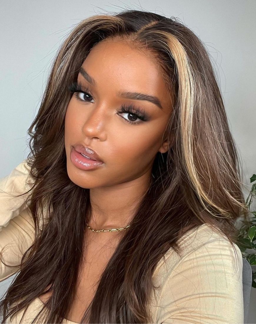 @onlybells_ has tone toned hair that is mostly dark brown but has two blonde streaks framing the face. Her hair is straight but with lots of volume. | ASOS Style Feed