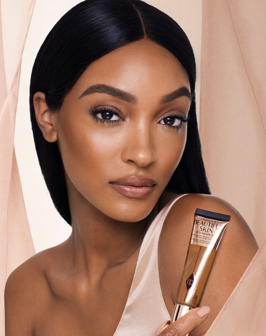 Supermodel Jourdan Dunn poses with the new Beautiful Skin Foundation from Charlotte Tilbury | ASOS Style Feed