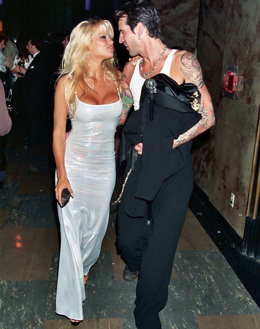 Pamela Anderson wears a long iridescent silver dress. | ASOS Style Feed 