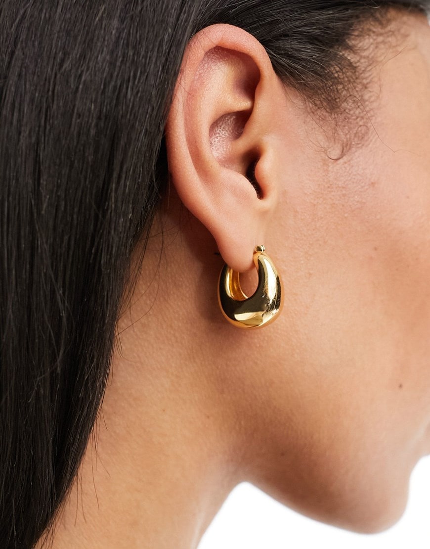 model wearing gold hoop earrings