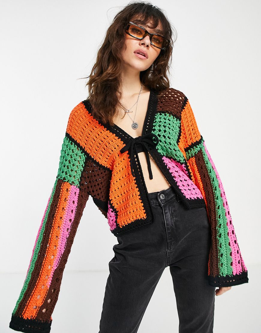 Woman wearing a crochet cardigan.
