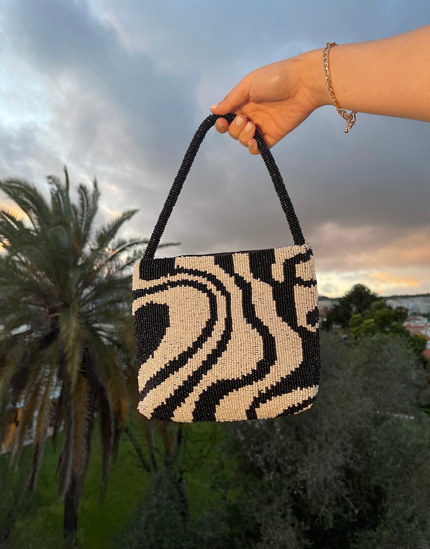 A black and white beaded bag.