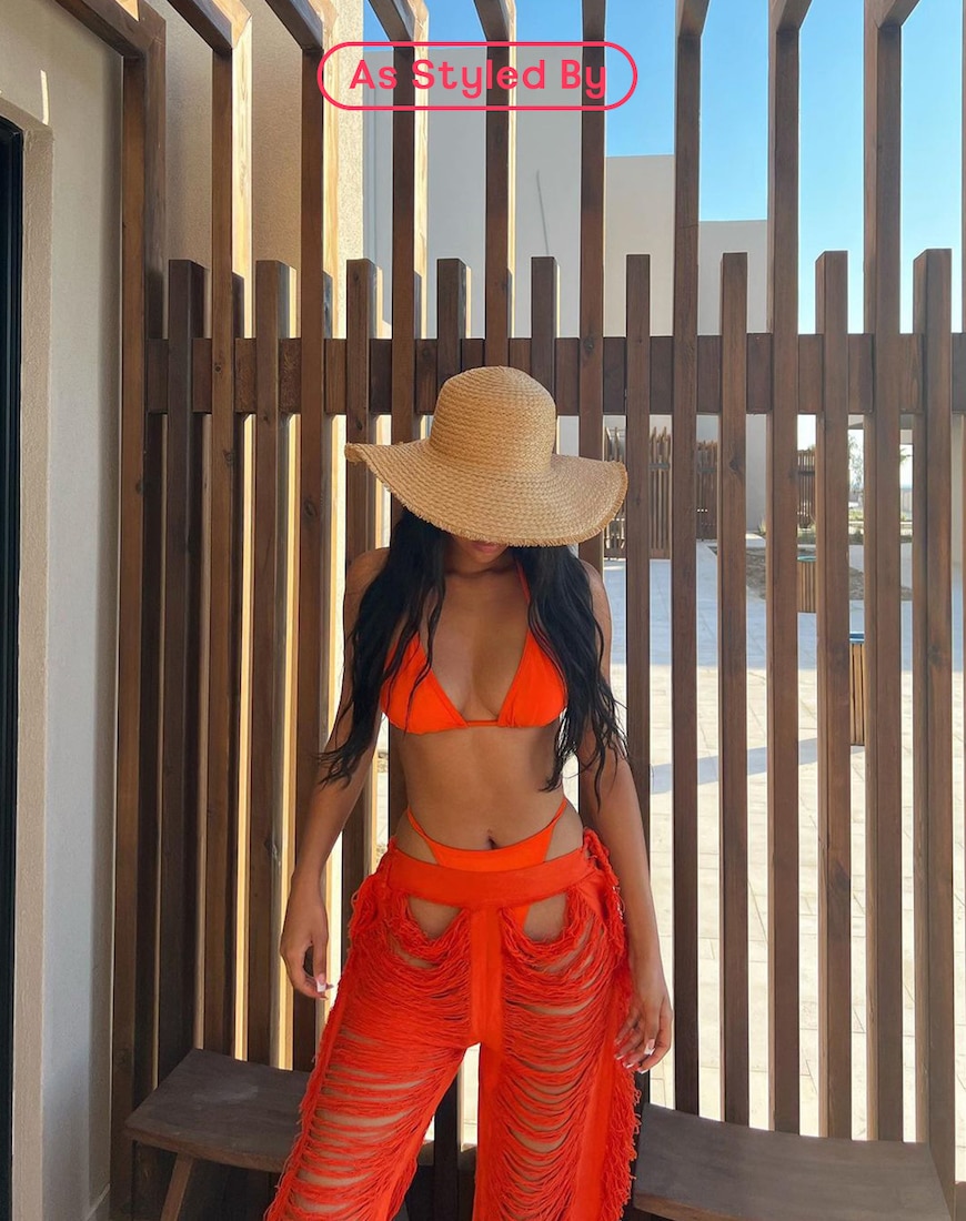 Woman wearing orange bikini and fringed trousers | ASOS Style Feed