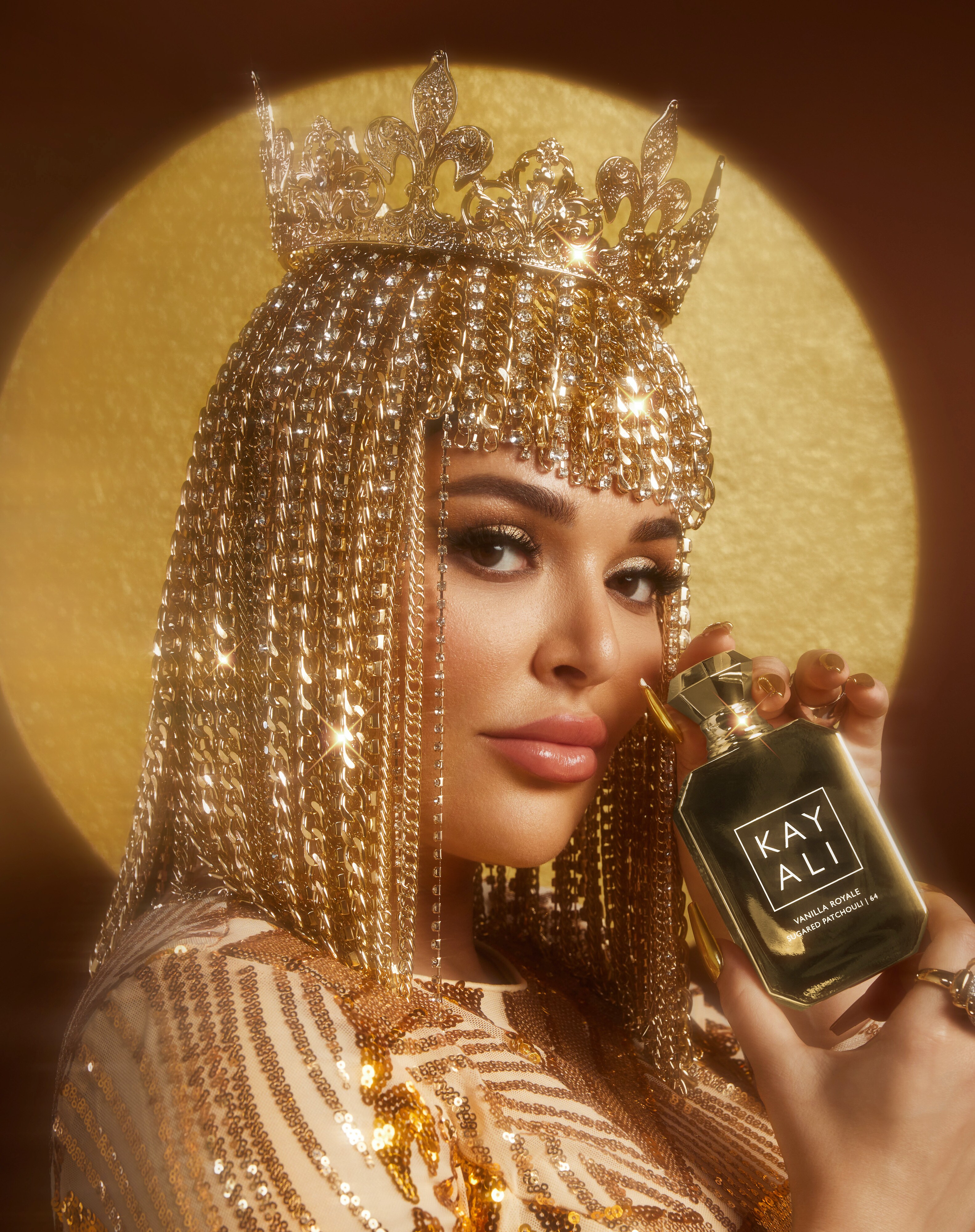 Mona Kattan holding a KAYALI fragrance
