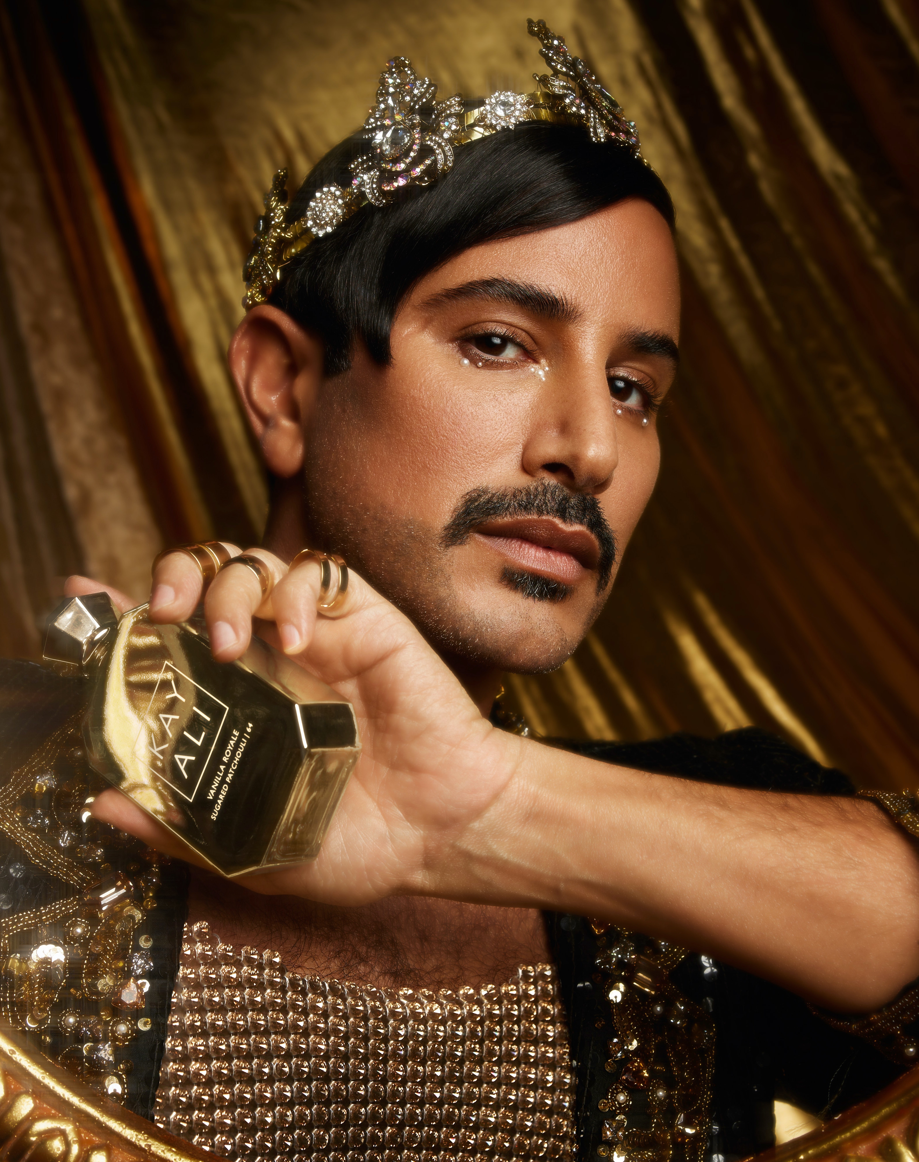 Man holding a KAYALI fragrance