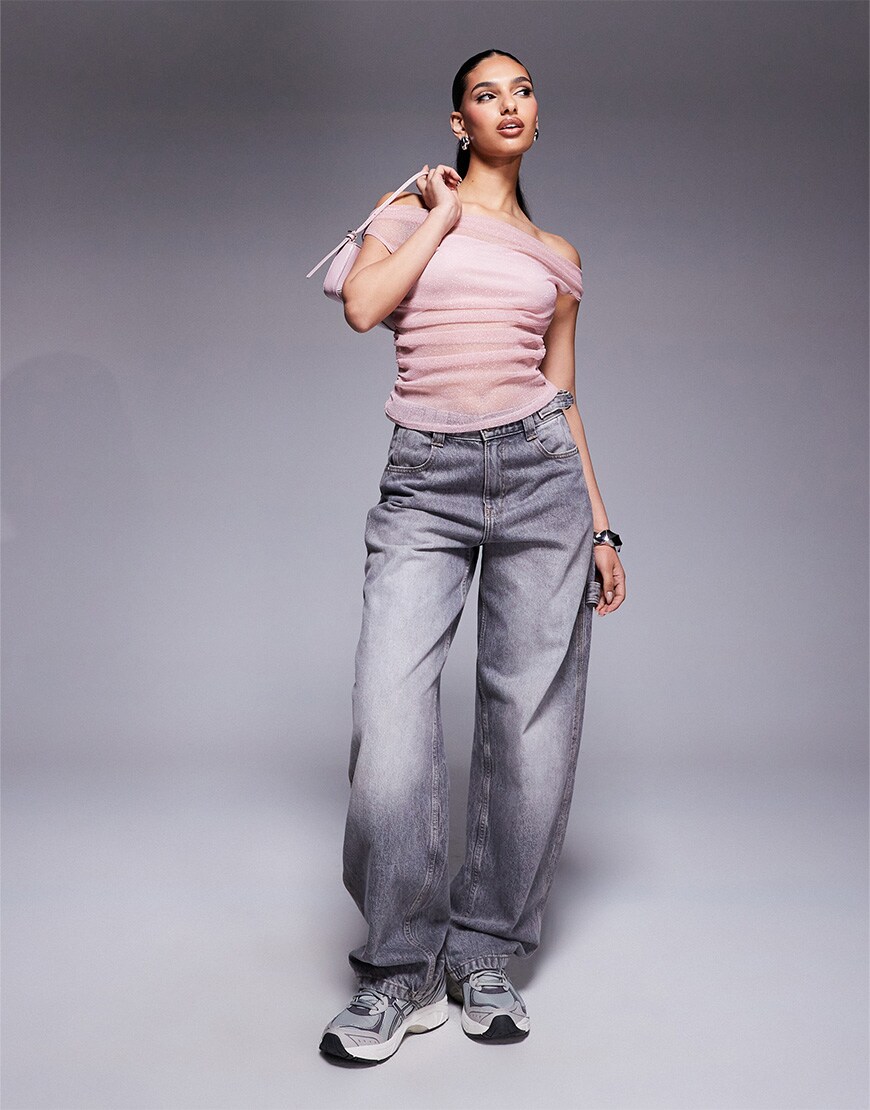 Model wearing pink glittery top and jean