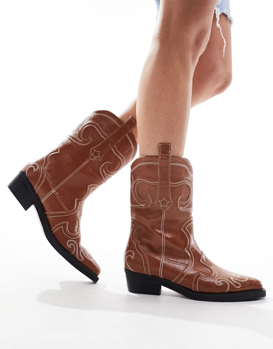A woman wearing brown cowboy boots | ASOS Style Feed