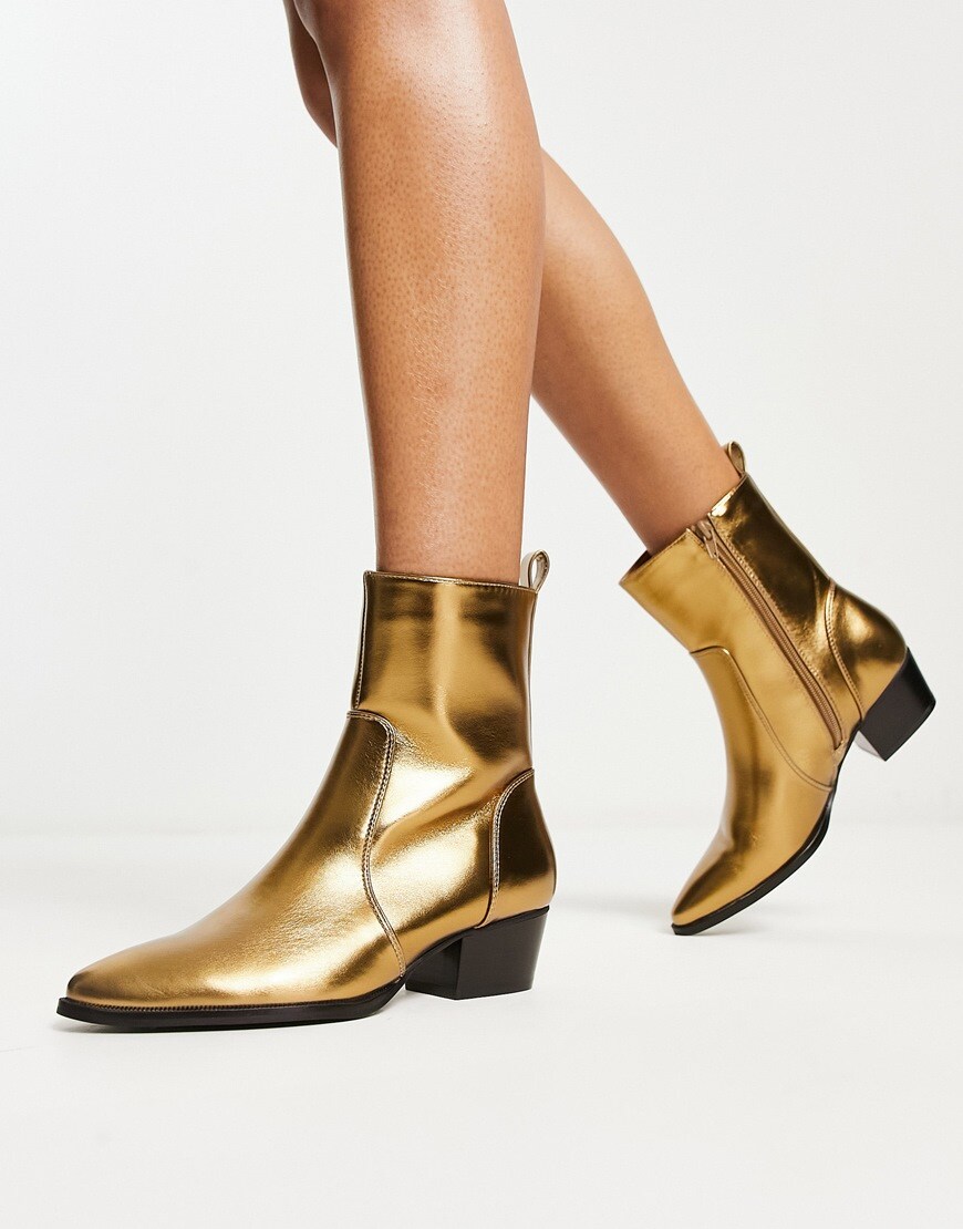 A woman wearing gold cowboy boots | ASOS Style Feed