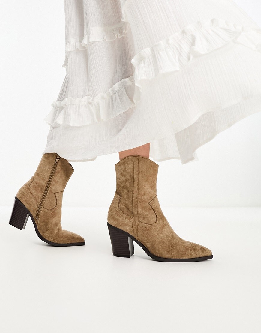 A woman wearing taupe cowboy ankle boots | ASOS Style Feed