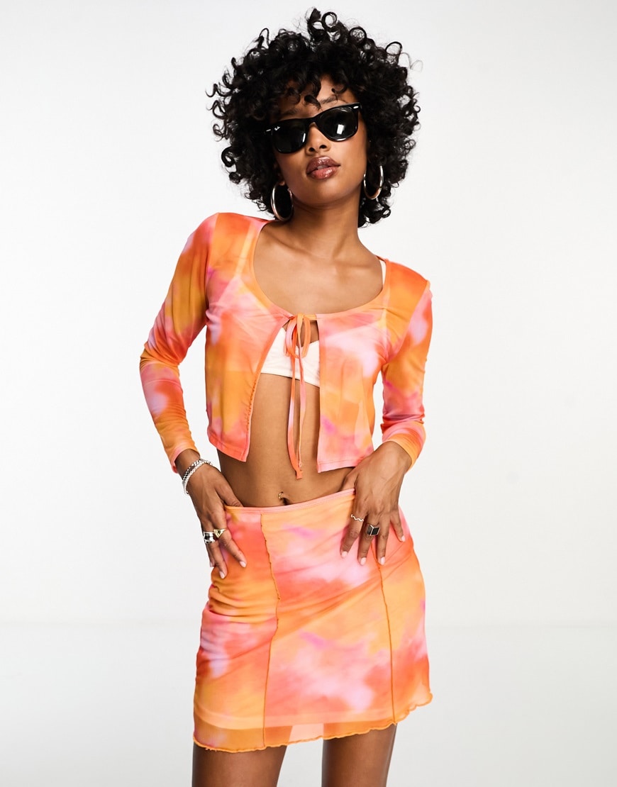 model in orange co-ord