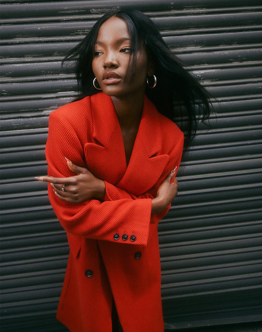model wearing red coat
