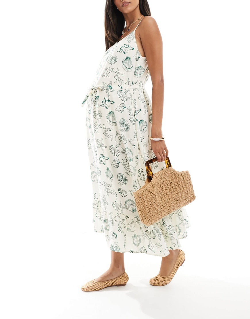 A woman in a green knitted maternity dress | ASOS Style Feed