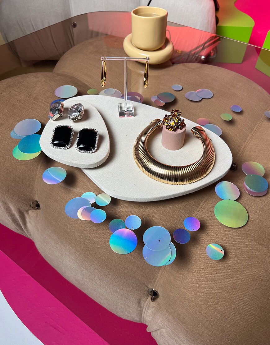 Jewellery laid on a table with sequins | ASOS Style Feed