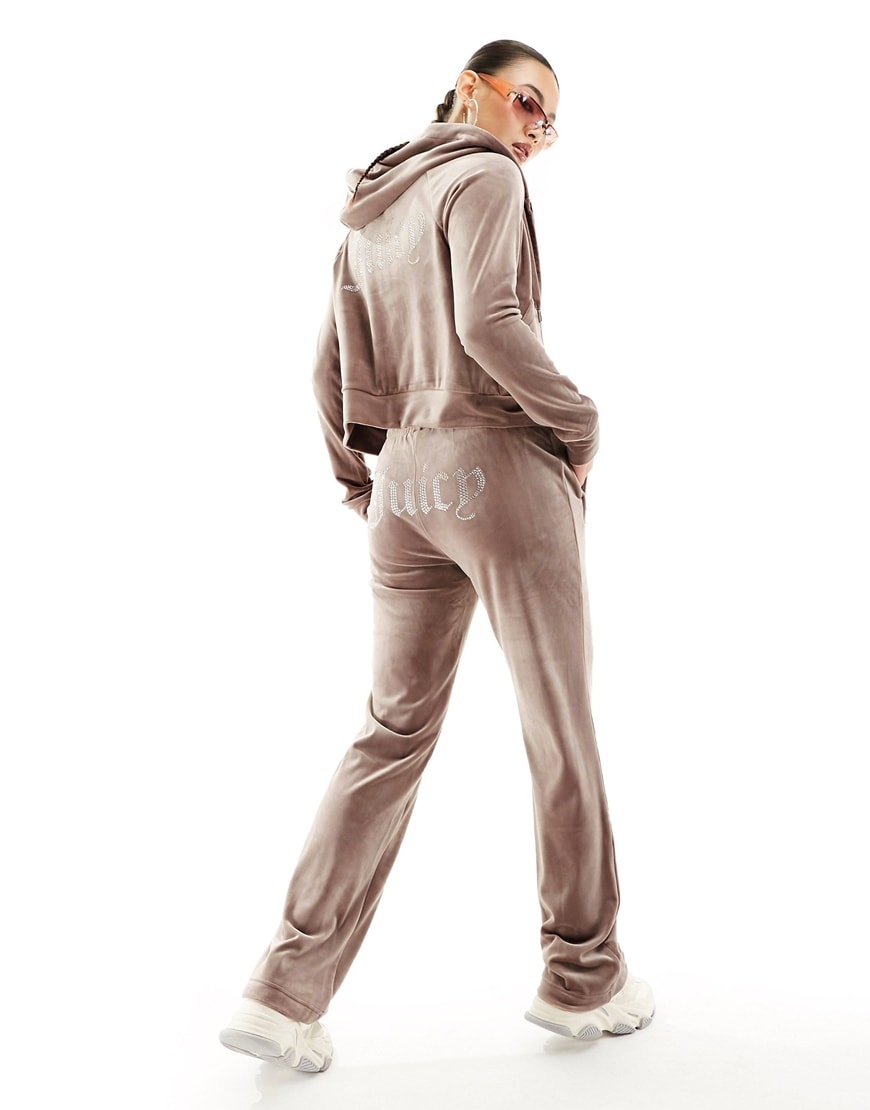 model wearing velour tracksuit bottoms