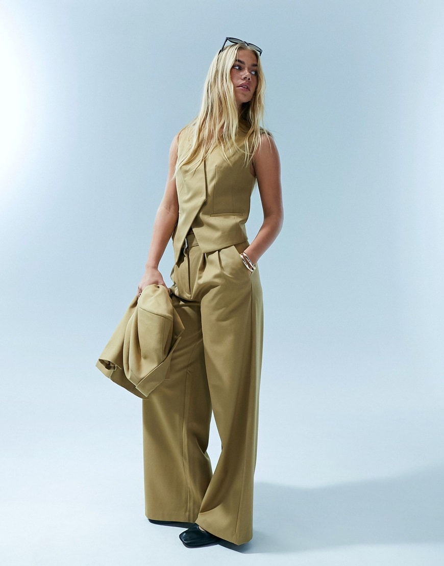 model wearing a tan suit