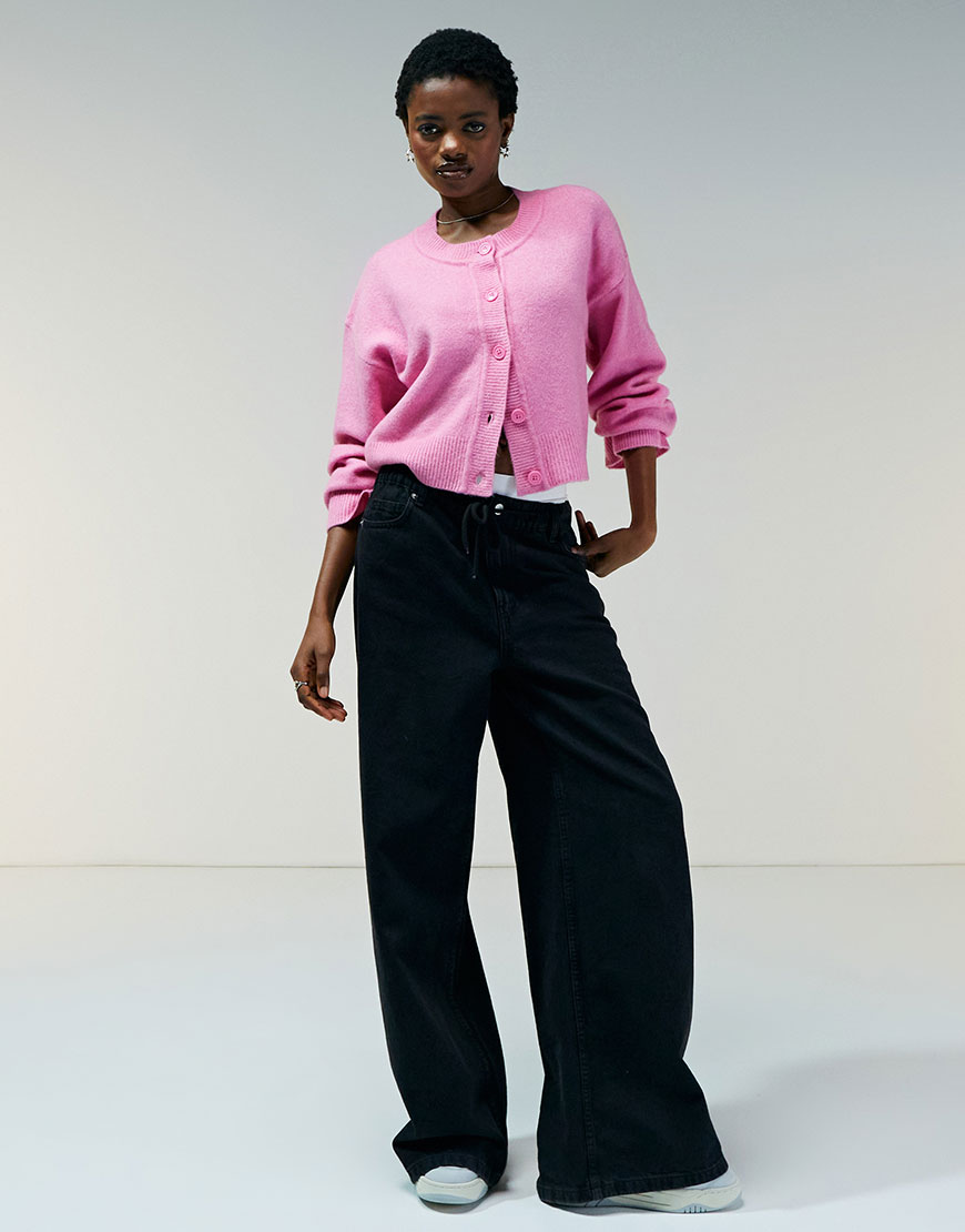 model wearing a pink knitted cardigan