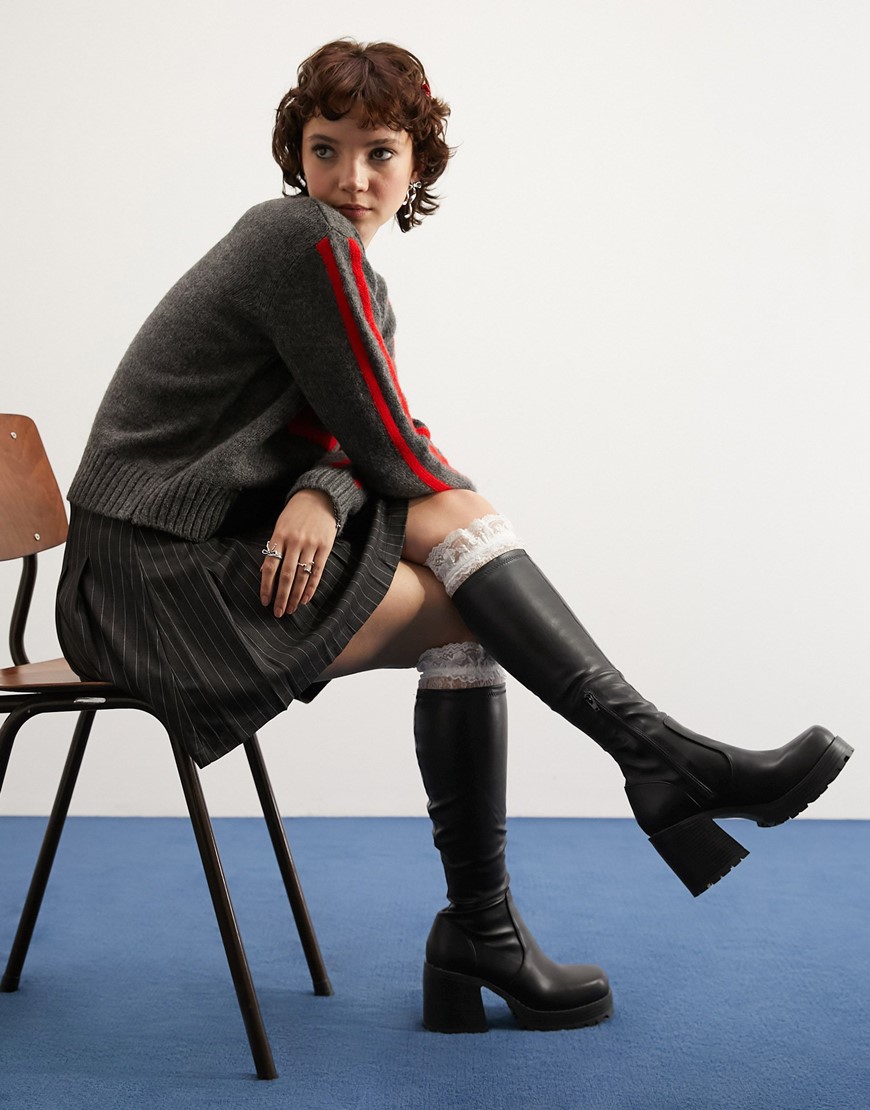 model wearing black knee high boots