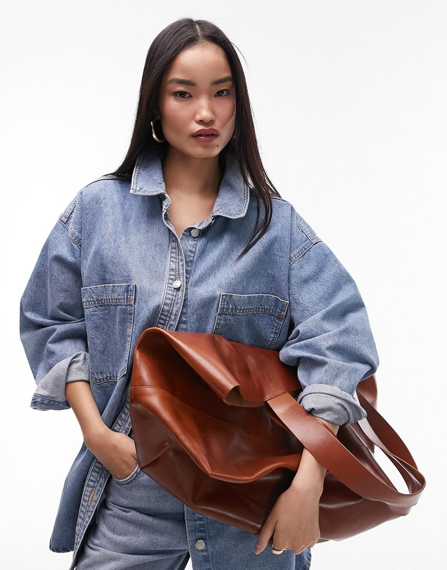 model wearing brown leather bag