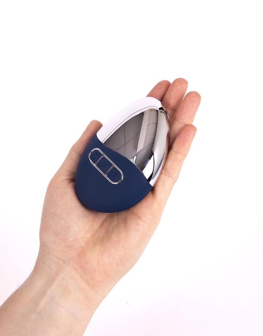 Model holding a navy blue pebble vibrator | ASOS Style Feed