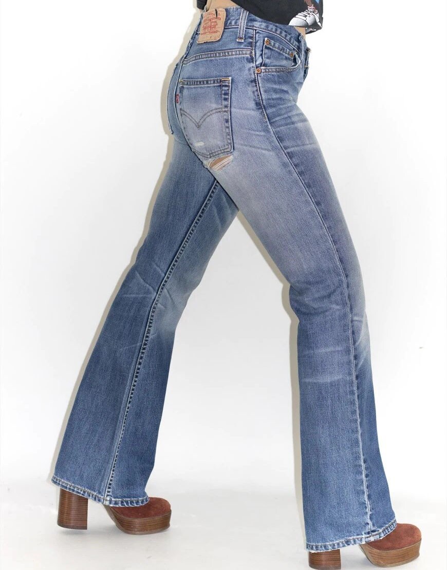 model wearing blue bootcut denim levis jeans