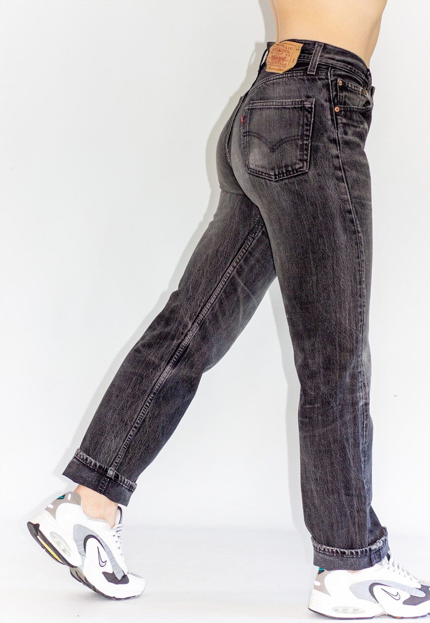 model wearing faded black vintage levis jeans