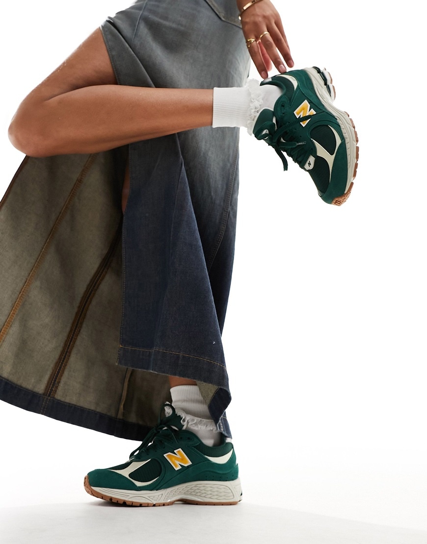 Woman wearing New Balance 2002 collegiate trainers in green and gold | ASOS Style Feed