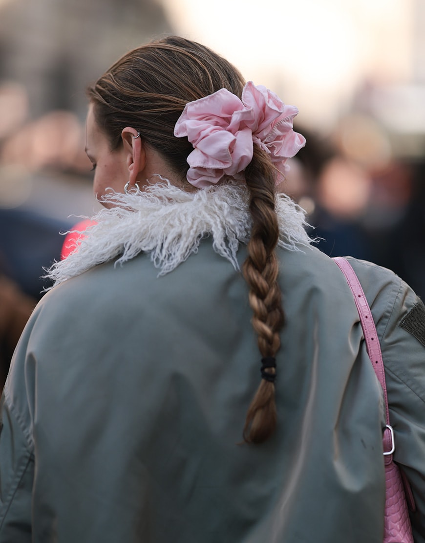 Woman wearing her hair in a plait with a large scrunchie | ASOS Style Feed