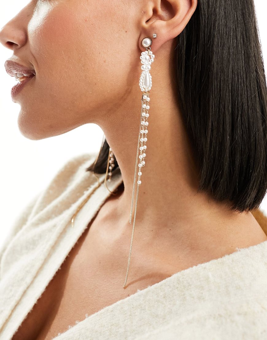 Woman wearing drop earrings with faux pearl design in gold tone | ASOS Style Feed